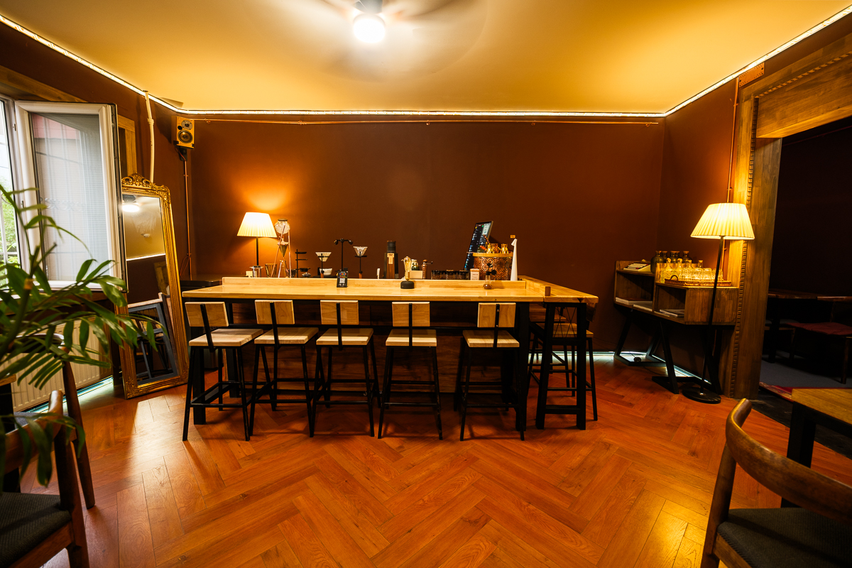 Bar seating along the counter with herringbone wood flooring
