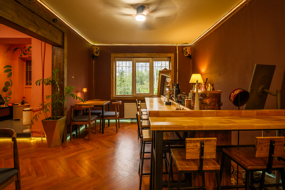 Seating area near the window with potted plants and warm lighting