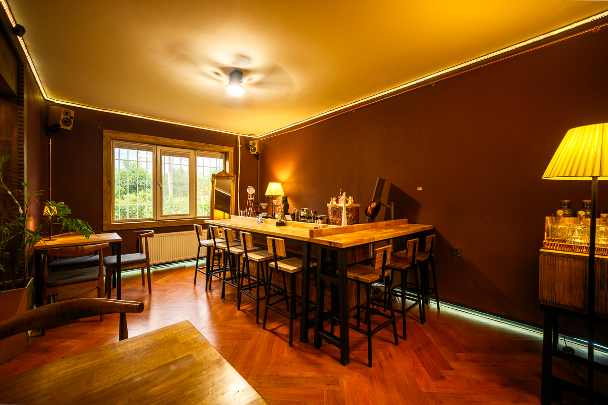 Wide view of the bar and seating area with parquet flooring
